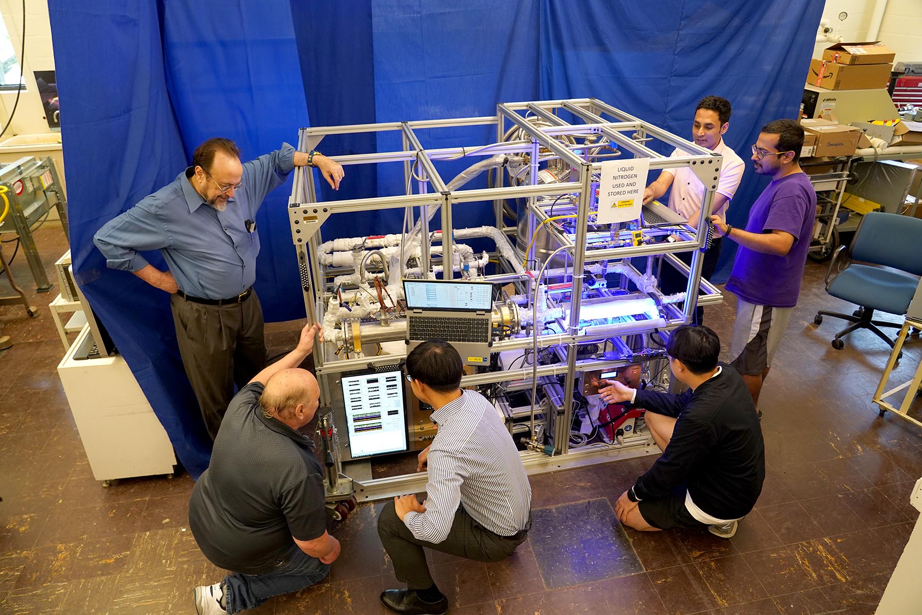 Issam Mudawar (far left) oversees an experiment to test how microgravity affects cryogenic liquids, which is vital to the future operation of space-based propellant depots. (Purdue University photo/Jared Pike)