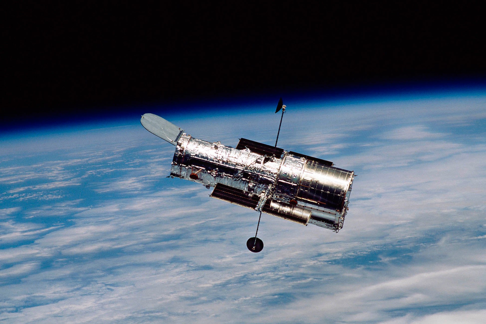 The Hubble Space Telescope is in low-Earth orbit, close enough for a Space Shuttle visit. This photo was taken after Hubble’s fourth servicing mission in 2002. The fifth and final mission took place in 2009. Credit: NASA